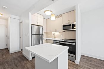 Modern kitchen with white quartz countertop and island